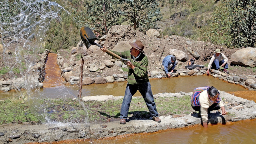 Farmers in Peru cleaning a canal which supplies them with river water