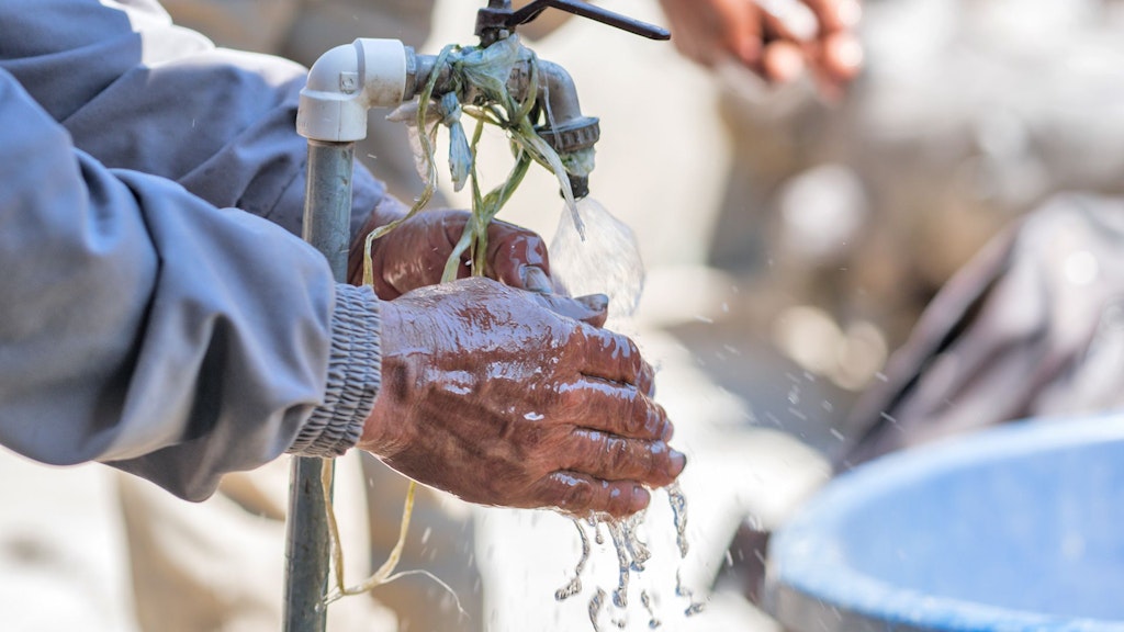 Someone washing their hands at one of the water management systems in Bolivia